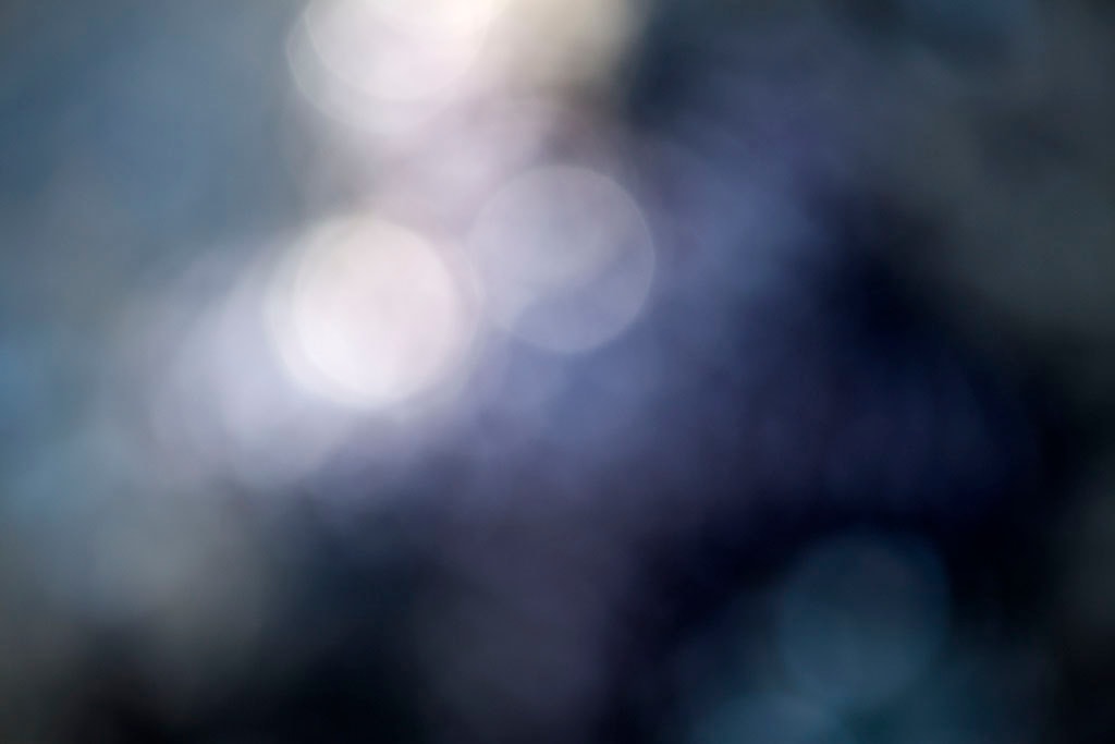 Depoe Bay, OR 2017 — deep blue-grey abstract with soft white bokeh orbs upper left