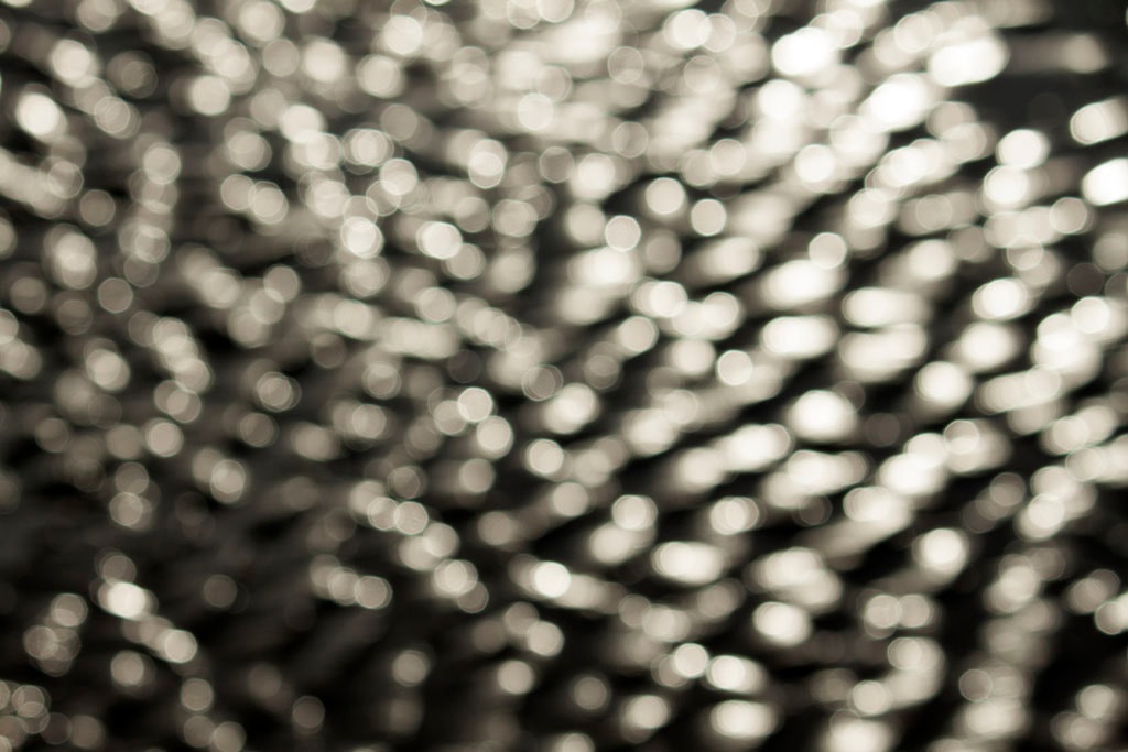 Depoe Bay, OR 2017 — silver bokeh water reflections, diagonal ripple pattern across full frame