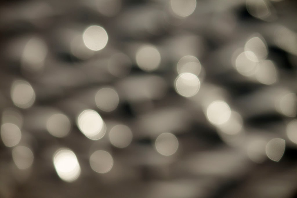 Depoe Bay, OR 2017 — cool silver bokeh, medium orbs scattered across dark grey tones