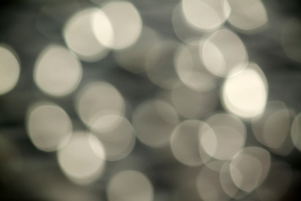 Depoe Bay, OR 2017 — bright silver bokeh, large overlapping orbs on cool grey