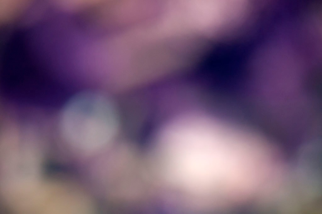Depoe Bay, OR 2017 — deep purple bokeh abstract, two soft orbs lower center on dark violet ground with diagonal shadow upper left