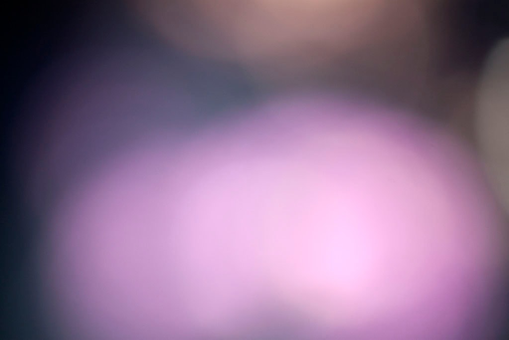 Depoe Bay, OR 2017 — soft lavender glow abstract, large pale pink orb rising from dark blue-grey ground with warm peach highlight upper center