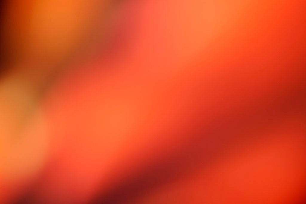 Maui, Hawaii 2018 — warm terracotta abstract, rich orange-red filling most of frame with dark brown shadow diagonal upper left and golden peach lower left corner