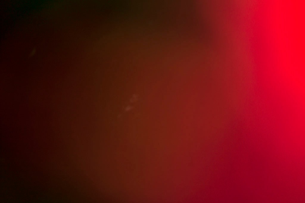 Maui, Hawaii 2018 — dark red abstract, deep near-black left transitioning to saturated crimson right with faint dust specks