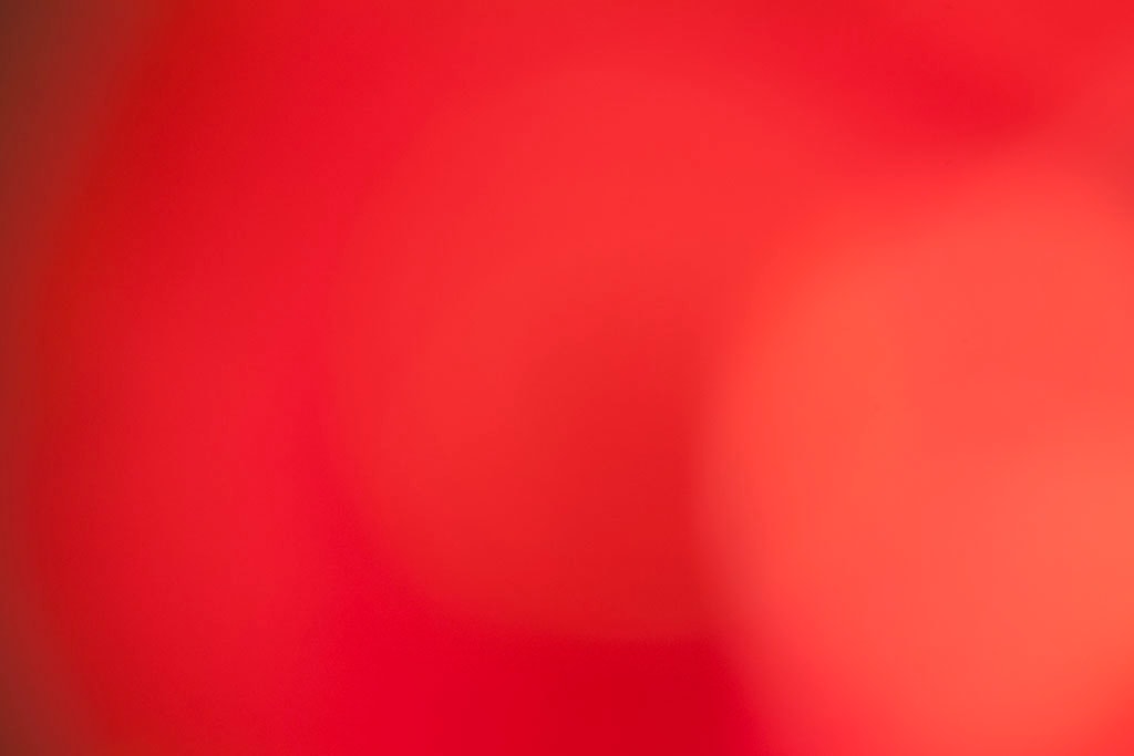 Maui, Hawaii 2018 — warm red abstract, soft coral-orange glow upper right on deep crimson ground with dark lower left