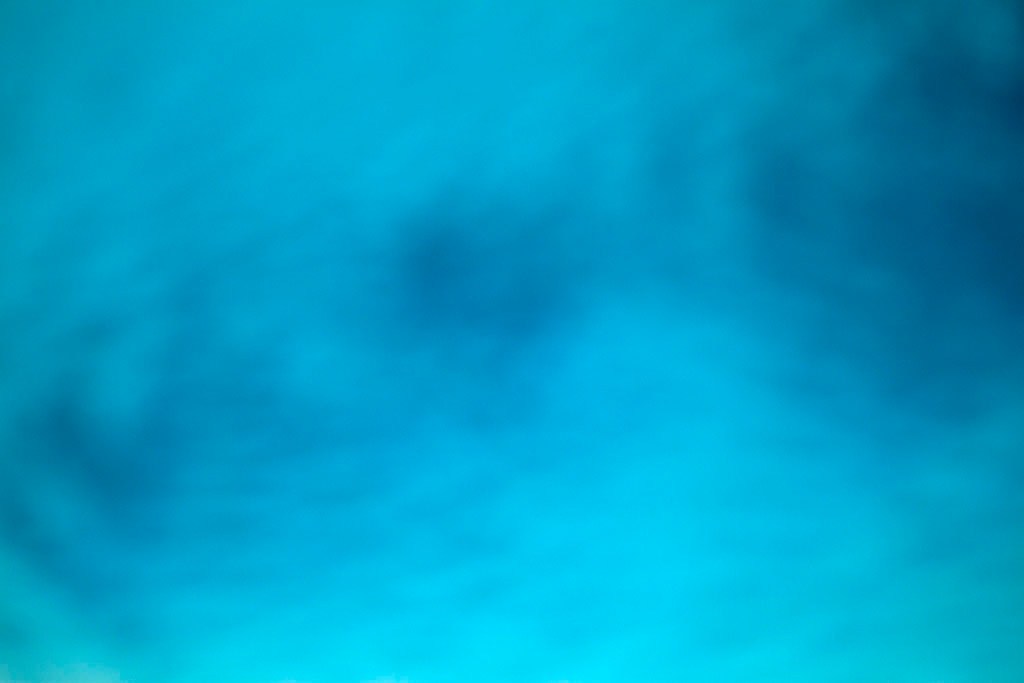 Yellowstone, WY 2016 — blurred teal blue sky with dark cloud swirl